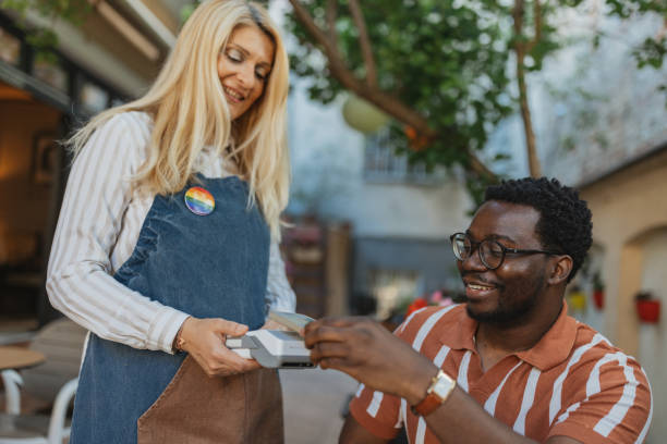 istock Smiling Waitress Serving Coffee to a Happy Customer at Cafe 2157931078