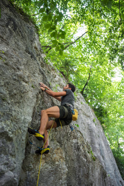 istock Focused Caucasian Rock Climber Scaling Cliff 2157931204