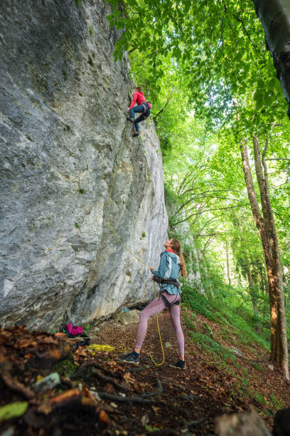 istock Caucasian Woman Ascending Rock Face with Partner on Belay 2157931221