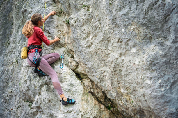 istock Resolute Female Rock Climber Scaling a Cliff 2157931261