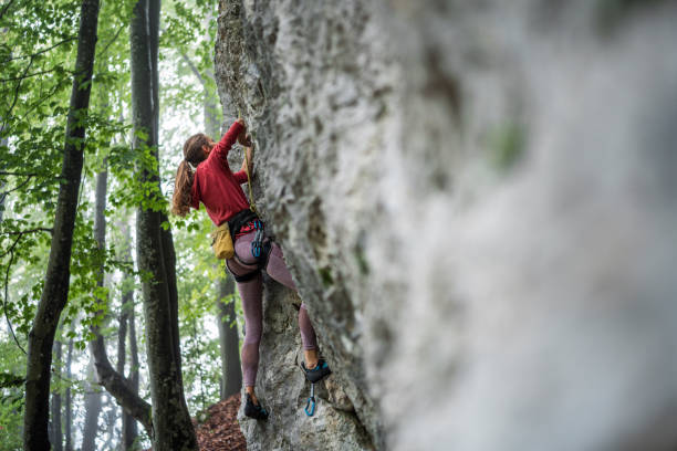 istock Caucasian Woman Tackles Challenging Rock Climbing Route 2157931286