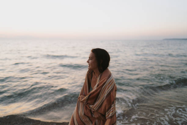 istock Young woman at the sandy beach at sunset 2157931831
