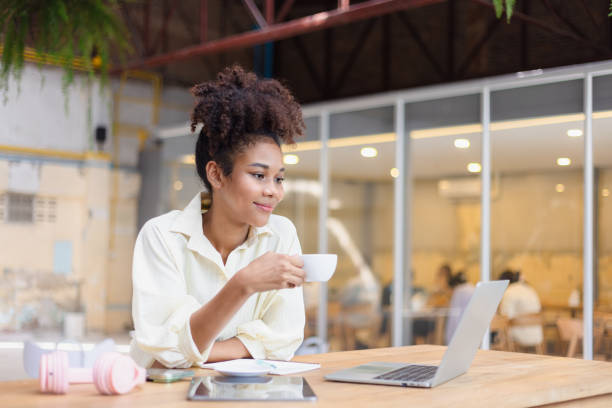 istock African American woman freelancer using tablet and working on laptop in office desk. 2157932175
