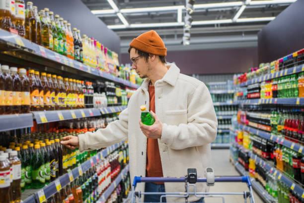 istock Man Choosing Beverage in Supermarket 2157933170