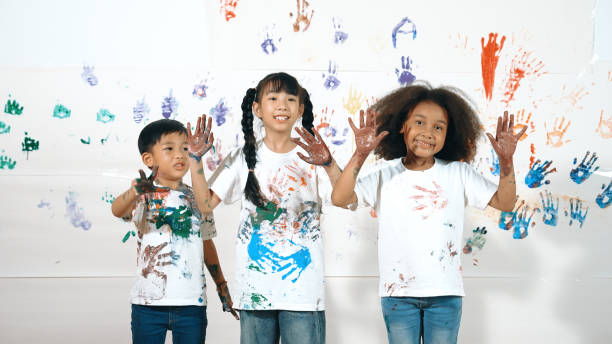 istock Diverse students put hands up together show colorful stained hands. Erudition. 2157935268