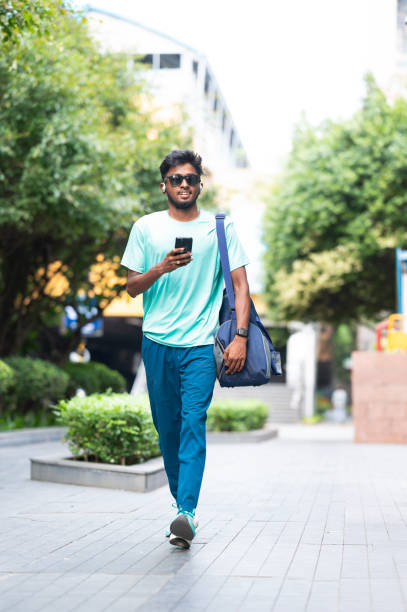istock Casual Urban Stroll with Bag and Smartphone 2157935654