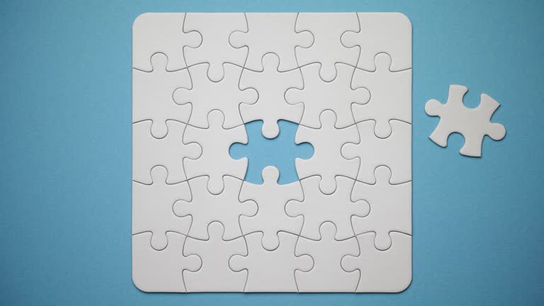 Stop motion animation of a blank jigsaw puzzle being constructed to completion.