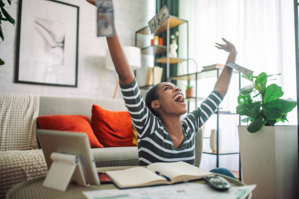 istock Happy black woman paying the bills online 2157937742