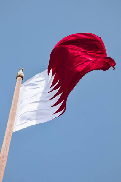 Waving flag of Qatar, in Doha