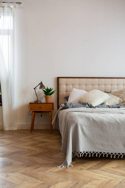 istock Cozy interior bed and window wooden floors  white wall 2157938869
