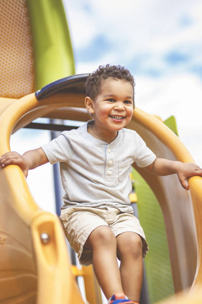 istock Happy 3 years old boy on a swing. Happy kid on playground 2157938891