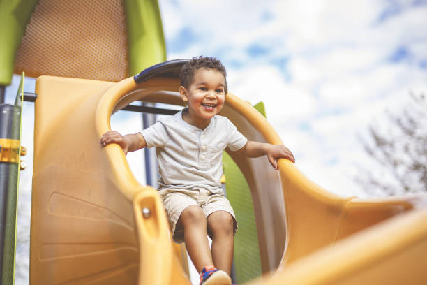 istock Happy 3 years old boy on a swing. Happy kid on playground 2157938892