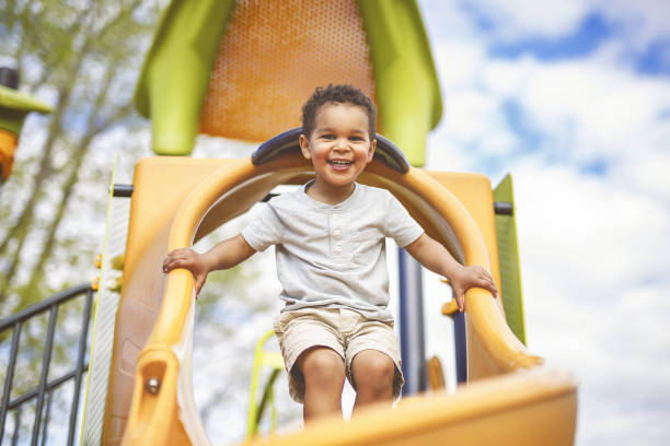 istock Happy 3 years old boy on a swing. Happy kid on playground 2157938895