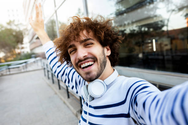 istock Young happy man taking selfie outdoors looking at camera. 2157939241
