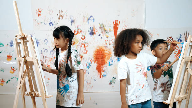 istock Diverse student painted or draw canvas at stained wall in art lesson. Erudition. 2157940274