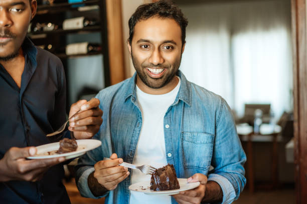 istock Friends Enjoying Chocolate Cake at a Casual Gathering 2157942731