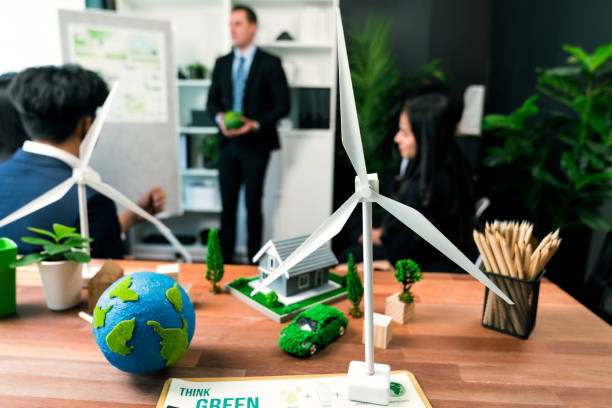 istock EV car model with mockup wind turbine on blurred background meeting. Quaint 2157945235