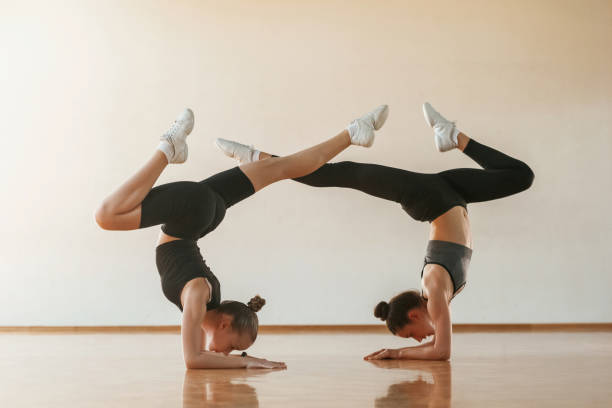 istock Doing duo practice. Kids are doing athletic exercises indoors together 2157946875