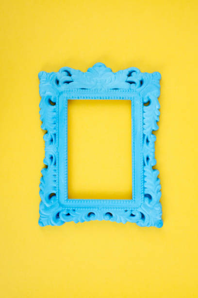 istock Blue painted baroque frame on yellow background, close up 2157947550