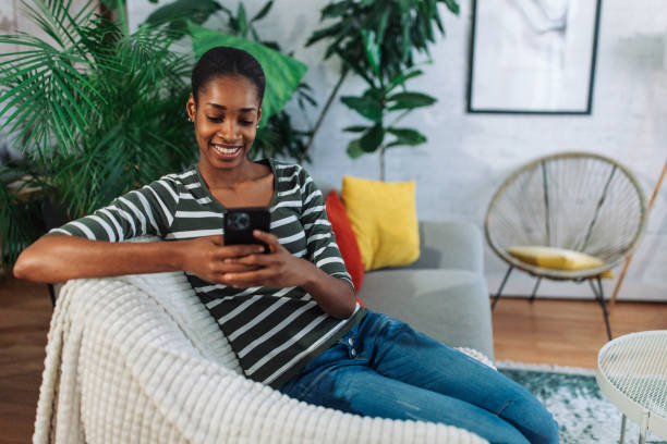 istock Black woman using a smart phone and smiling 2157947633