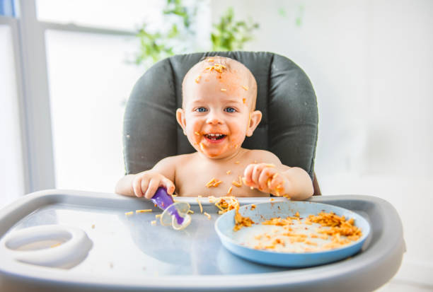 istock Little baby eating her dinner and making a mess 2157948161