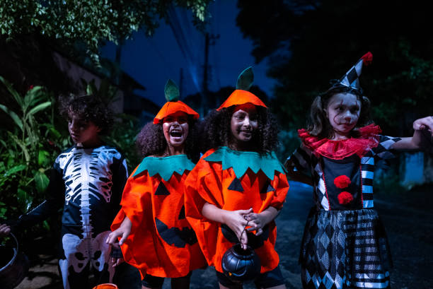 istock Kids costumed having fun on Halloween on the street 2157948507