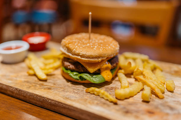 istock Cheeseburger With French Fries On The Table In A Pub 2157948635