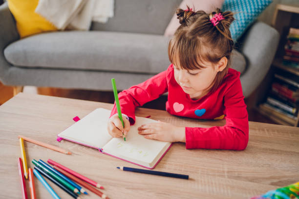 istock Cute small girl learning counting and math at home 2157951074