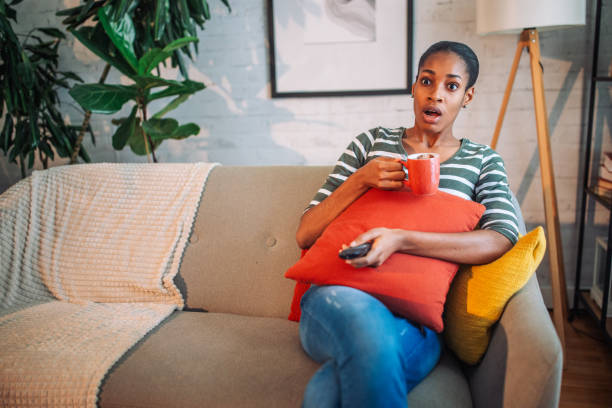 istock Shocked black woman watching TV 2157951094