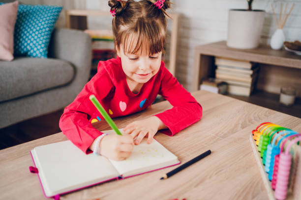istock Cute small girl learning counting and math at home 2157951175