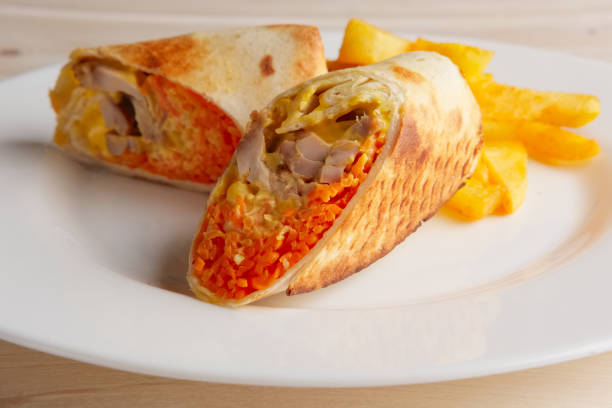 istock Meat, spicy carrot, cabbage and cheese rolled up in thin pitta bread 2157951244