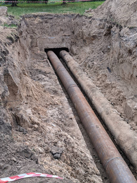 istock pair of utility tubes in ground 2157952989