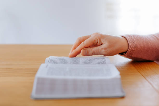 istock Close-Up of Unrecognizable Hands Turning Pages of a Book 2157954514