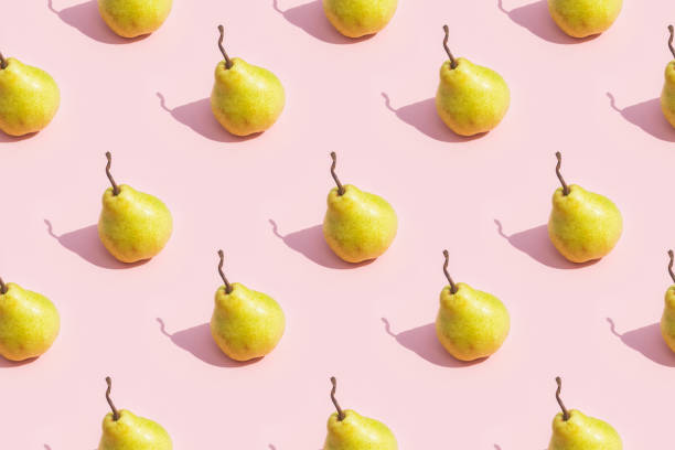 istock Creative seamless pattern of yellow ripe pear on pink background 2157954687