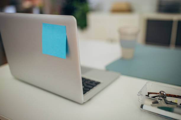 istock Grey laptop with a blue sticky note close-up 2157955062
