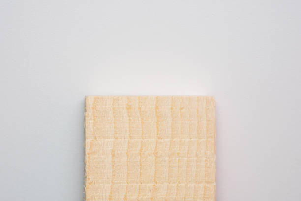 istock Untreated wooden plank on a light background. Wood block for construction. Board with small chips. 2157955624