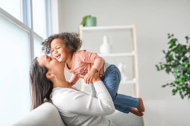 istock Mother with little daughter at home sofa 2157955769