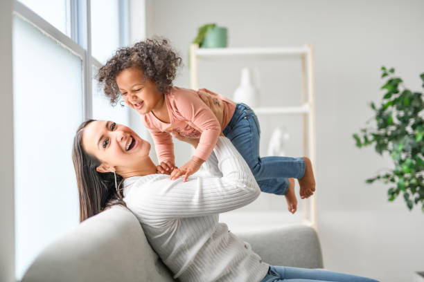 istock Mother with little daughter at home sofa 2157955774