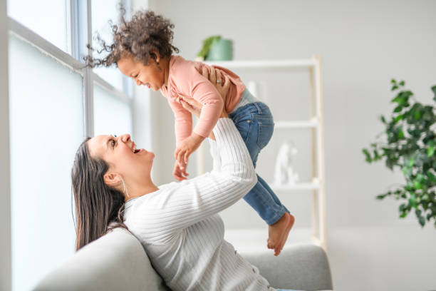 istock Mother with little daughter at home sofa 2157955775