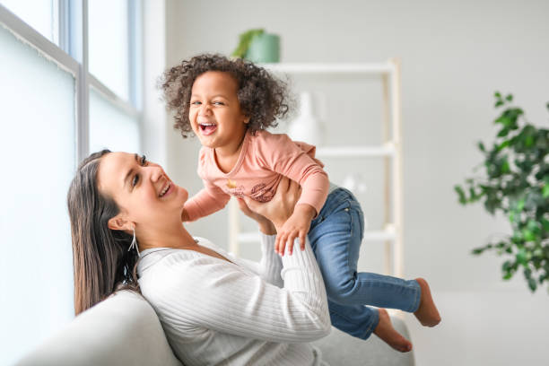 istock Mother with little daughter at home sofa 2157955786