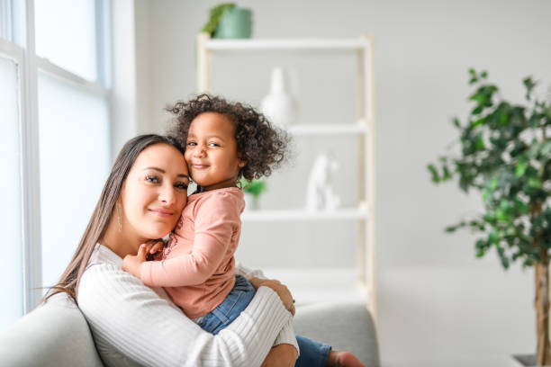 istock Mother with little daughter at home sofa 2157955815