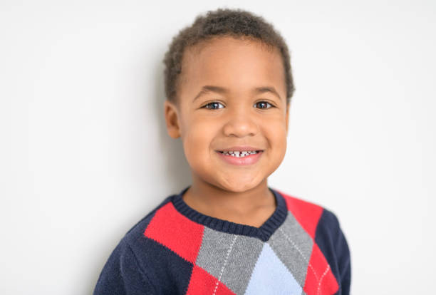 A Cute happy 3 year old American boy smiling for the camera