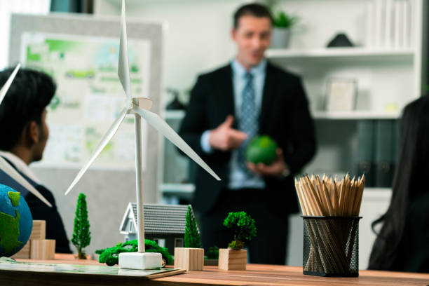 istock EV car model with mockup wind turbine on blurred background meeting. Quaint 2157957136