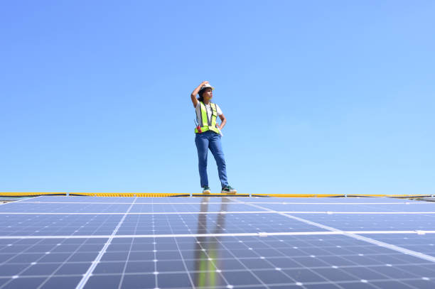 istock Engineer working setup Solar panel at the roof top. Engineer or worker work on solar panels or solar cells on the roof of business building 2157958272