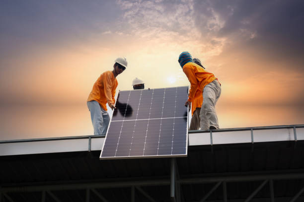 istock Worker installs solar panels. Worker installs solar panels at a solar farm field. 2157958332