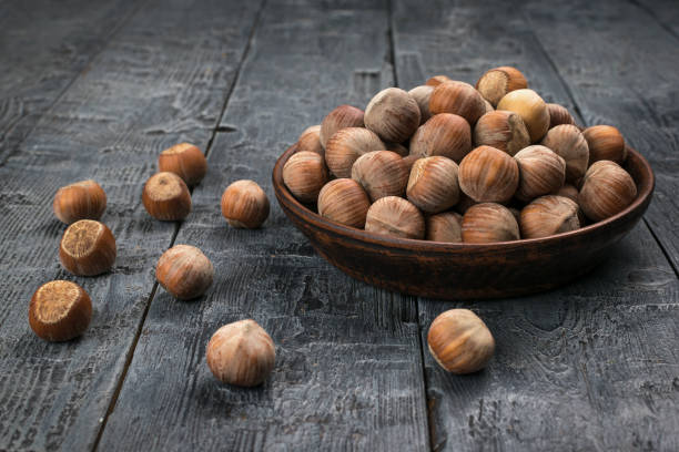 istock Rustic Bowl of Hazelnuts on Dark Wooden Table Nutritious Snack in Natural Setting 2157958575
