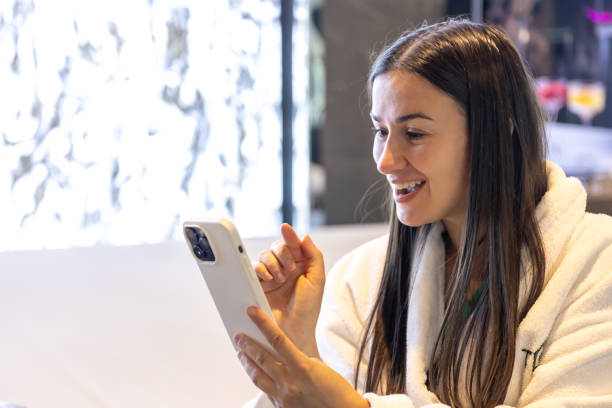 istock A young woman is relaxing in a spa complex and using a smartphone. 2157959751