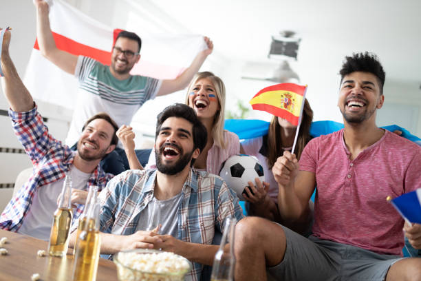 istock Group of multi-ethnic people celebrating football game 2157959892