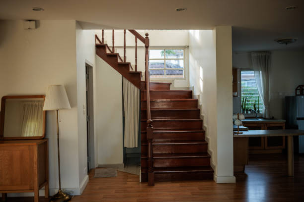 Modern home interior that exudes warmth and simplicity. The wooden staircase leading to the upper level blends seamlessly with the wooden flooring.