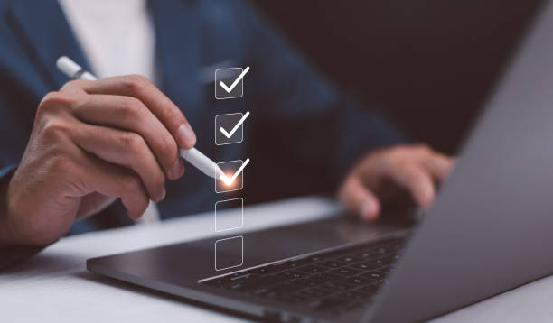 istock Business performance checklist, businessman using laptop doing online checklist survey, filling out digital form checklist, take an assessment, questionnaire, evaluation, online survey, online exam. 2157963625